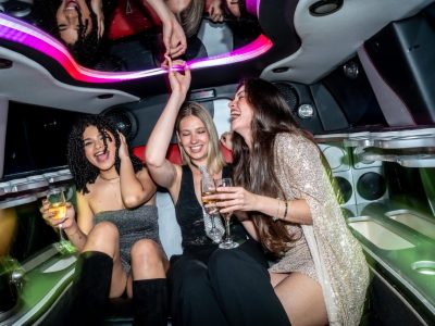 three young women laughing and celebrating in a luxury Chicago limo